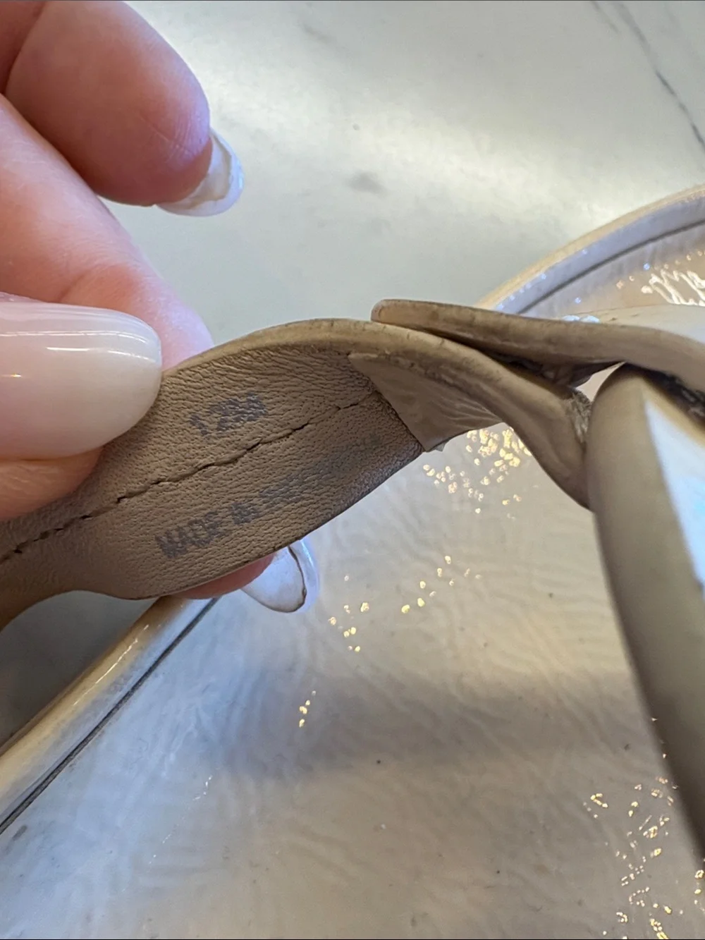 Tory Burch Patent Logo Thong Sandals in Light Beige with a chunky heel.